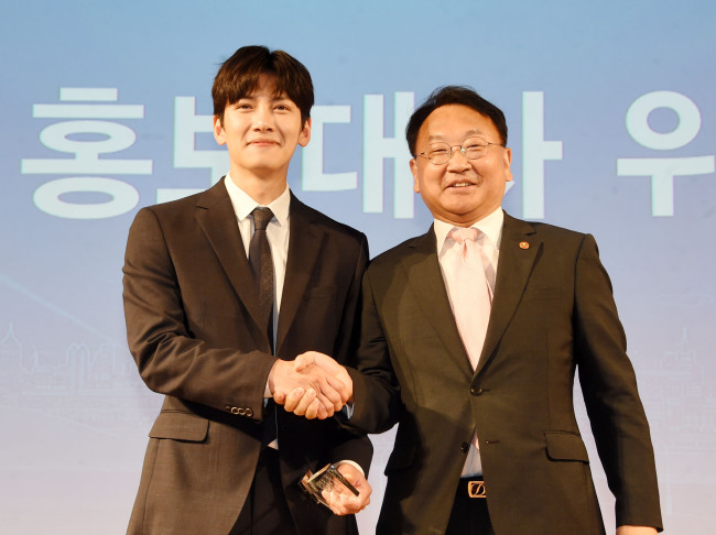 유일호(오른쪽) 부총리 겸 기획재정부 장관이 16일 서울 광화문 KT올레 스퀘어에서 열린 ‘ 2017 아시아인프라투자은행(AIIB) 연차총회 홍보대사 위촉식’에 참석, 홍보대사 탤런트 지창욱과 기념촬용하고 있다.［사진제공=기획재정부］