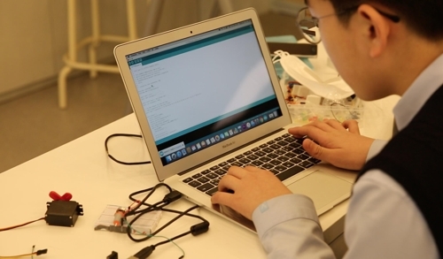 This photo provided by Code Academy on May 17, 2017, shows a student working on programming at the private institute in southern Seoul. (Yonhap)