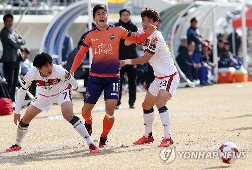 Gangwon FC forward Lee Keun-ho (center) battles FC Seoul's Kim Chi-woo (left) and Lee Seok-hyun during their K League Classic match at Alpensia Ski Jumping Centre in PyeongChang, Gangwon Province on March 11, 2017. (Yonhap)