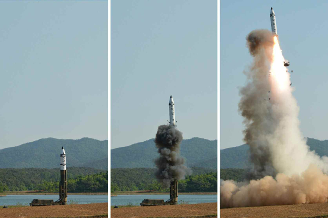 A set of photos carried by North Korea`s main newspaper, the Rodong Sinmun, on May 22, 2017, shows the test-firing of a new intermediate-range ballistic missile, known as the Pukguksong-2, in North Korea. (For Use Only in the Republic of Korea. No Redistribution) (Yonhap)
