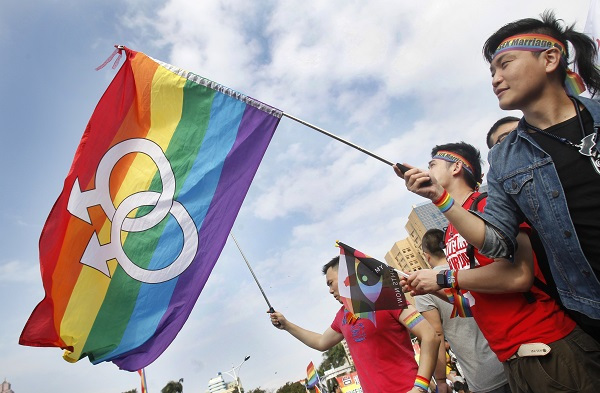 In this Dec. 10, 2016, file photo, supporters of LGBT and human rights wave rainbow flags during a rally supporting a proposal to allow same-sex marriage in Taipei, Taiwan, on the World Human Rights Day. (AP)