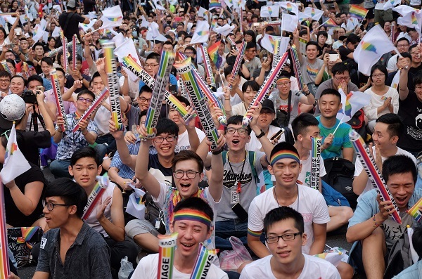 Same-sex activists hug outside the parliament in Taipei on May 24, 2017 as they celebrate the landmark decision paving the way for the island to become the first place in Asia to legalise gay marriage. (AFP)