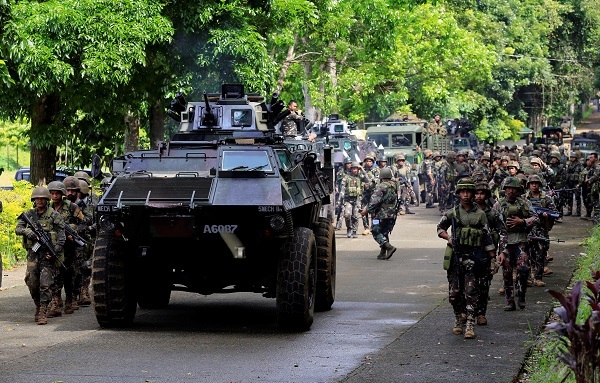 An armoured personnel carrier and government troops march to begin their assault with insurgents from the so-called Maute group, who have taken over large parts of Marawi City, southern Philippines May 25, 2017. (Reuters)