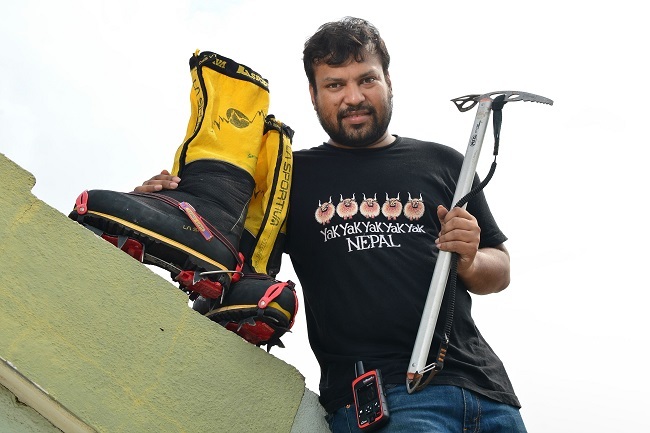 In this photograph taken on May 25, 2017, Indian mountaineer Satyarup Siddhanta poses for a photograph with the equipment he had with him during his successful bid to summit Mount Everest, at his home in Bangalore. (AFP-Yonhap)
