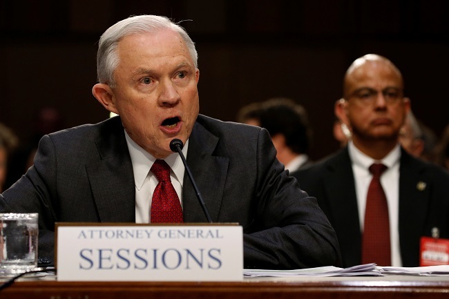 US Attorney General Jeff Sessions reacts angrily to questions from US Senator Ron Wyden (D-OR) as he testifies before a Senate Intelligence Committee hearing on Capitol Hill in Washington, US, June 13, 2017. (Reuters)