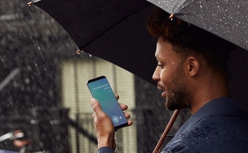 The file photo, dated May 1, 2017, shows a model using Samsung's smart voice assistance program, Bixby. (Yonhap)