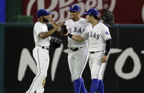 In this Associated Press photo, outfielders of the Texas Rangers -- Delino DeShields, Carlos Gomez and Choo Shin-soo (L to R) -- celebrate their 10-4 victory over the Seattle Mariners at Global Life Park in Arlington in Texas on June 17, 2017. (Yonhap)