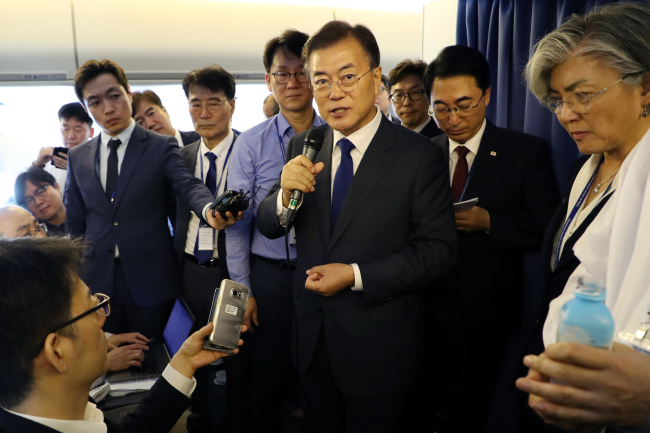President Moon Jae-in addresses the media aboard the flight to Washington DC on Wednesday. Yonhap