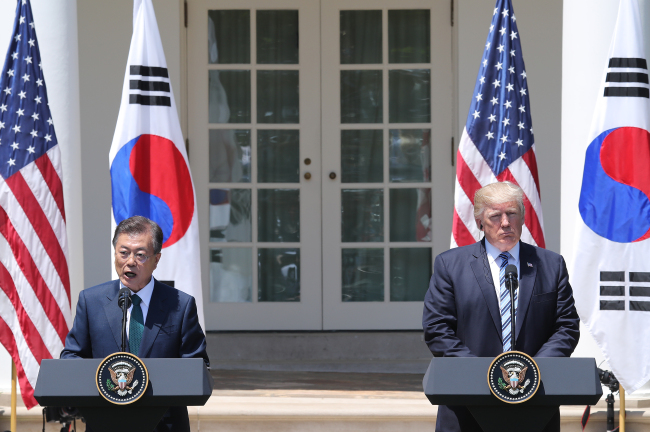 President Moon Jae-in (left) speaks during a joint news conference with US President Donald Trump after their summit at the White House in Washington on Friday. (Yonhap)