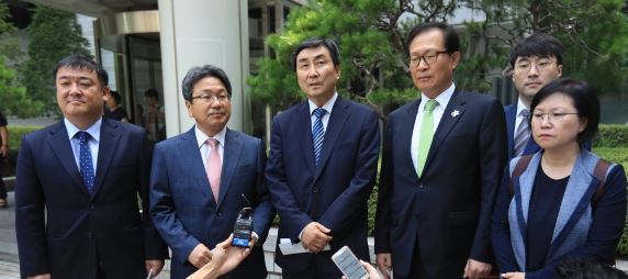 Ex-Rep. Kang Ki-jung, incumbent Rep. Lee Jong-kul of the Democratic Party, former Reps. Moon Byung-ho and Kim Hyun (from L to R) speak to reporters after they are acquitted by a higher court of charges over the illegal detention of an intelligence agent, in Seoul on July 6, 2017. (Yonhap)