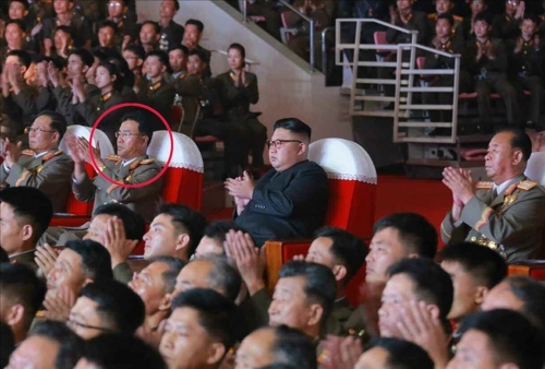 Jang Chang-ha, president of the Academy of National Defense Science, seen sitting next to leader Kim Jong-un (Yonhap)