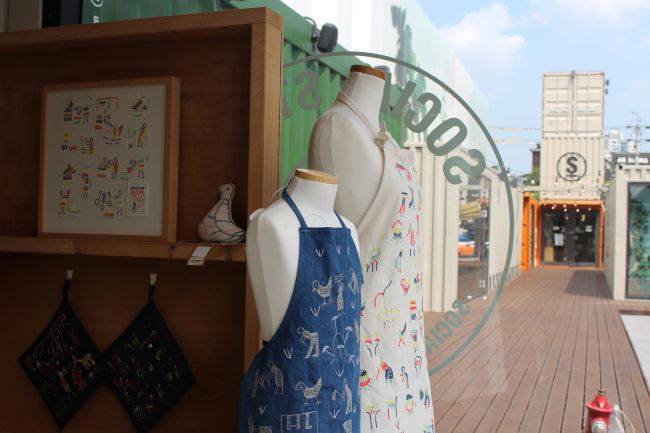 Chef pinafores are for sale at a Social Stand shop. (Kai Potter/The Korea Herald)