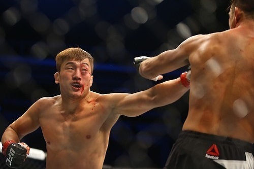 In this file photo taken on Nov. 28, 2015, South Korean mixed martial arts (MMA) fighter Bang Tae-hyun (L) lands a punch on Leo Kuntz of the United States during their lightweight bout at the UFC Fight Night 79 at Olympic Gymnastics Arena in Seoul. (Yonhap)