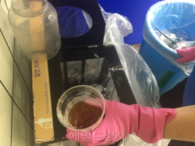 찜통더위 속에 테이크아웃 음료를 찾는 시민들이 많아지면서 여기저기서 일회용컵 쓰레기로 몸살을 앓고 있다. 지난 17일 지하철 청소원 현모(57) 씨가 일회용컵 쓰레기를 일일히 분리하는 모습. [사진=이현정 기자/rene@heraldcorp.com]