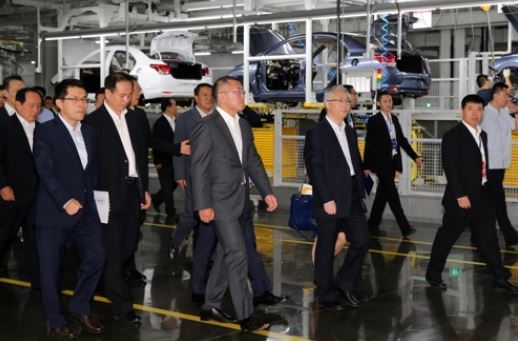 In this photo taken on July 18, 2017, Hyundai Motor Vice Chairman Chung Eui-sun in a dark gray suit, and officials from the carmaker and the local government look around its fifth plant in Chongqing, Southwest China. (Yonhap)