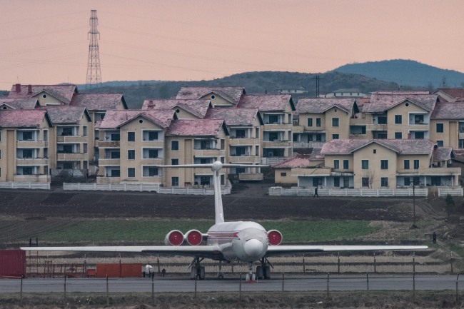 This file photo taken on April 17, 2017 shows an Air Koryo aircraft as it sits parked in front of houses outside Pyongyang airport. (Yonhap-AFP)
