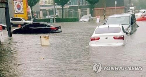 (사진=연합뉴스)서울, 인천, 경기북부 일부에 호우경보가 내려진 23일 오전 인천 남구 동양장사거리 인근 도로가 침수돼 차량이 물에 잠겨 있다. 2017.7.23
