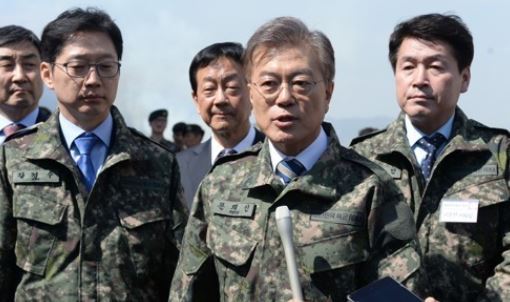 Moon Jae-in, elected South Korea's new president, speaks to reporters while clad in a military uniform during his visit to an Army firing test site in this file photo. (Yonhap)