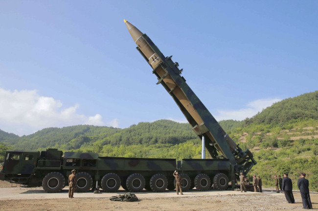 North Korean leader Kim Jong Un, second from right, inspects the preparation of the launch of a Hwasong-14 intercontinental ballistic missile in North Korea on July 4. (AP-Yonhap)