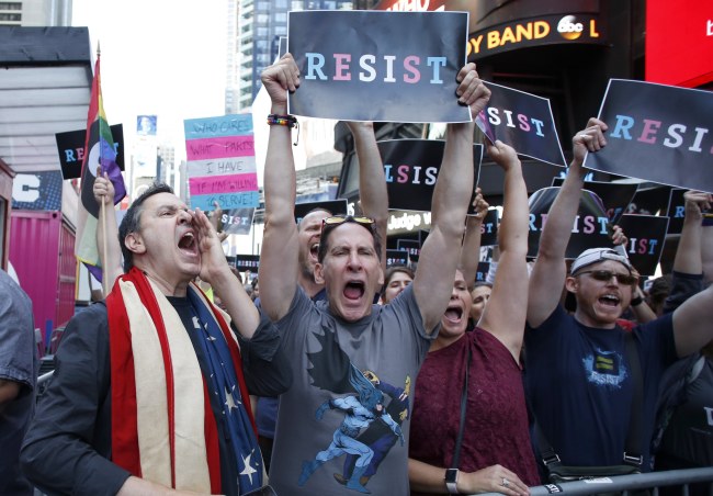 People protest US President Donald Trump announcement that transgender people will not be allowed to serve in the US military in Times Square, New York, Wednesday.   EPA-Yonhap