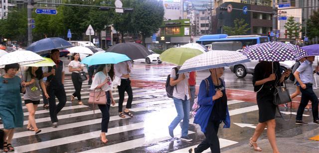 장마의 끝에서 중부지방에 호우특보가 내렸다. 31일 오전 서울 광화문사거리에서 시민들이 우산을 쓰고 바쁘게 출근하고 있다.  정희조 기자/checho@