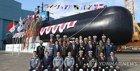 This file photo provided by Daewoo Shipbuilding & Marine Engineering on Oct. 24, 2016, shows Daewoo and Indonesian officials posing in a launching ceremony of a submarine bound for Indonesia. (Yonhap)