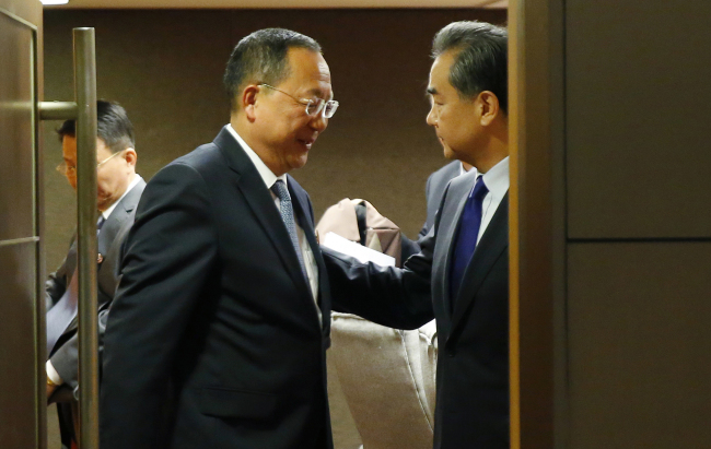 Ri Yong-ho, left, and Wang Yi (AP-Yonhap)