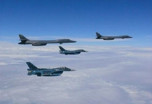 Two US Air Force B-1B bombers (top) perform a flight mission away from Guam in this photo posted on the Pacific Air Force's website. (Yonhap)