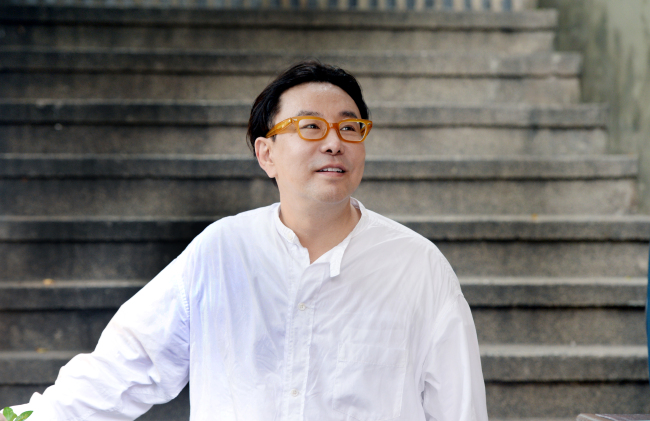 Creative director Jung Ku-ho poses at a cafe in Itaewon, Seoul on July 21. (Park Hyun-koo/The Korea Herald)