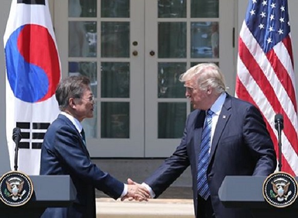 South Korean President Moon Jae-in (L) shakes hands with US President Donald Trump during a joint press conference following their bilateral summit at the White House, Washington, on June 30, 2017 (US time). (Yonhap)