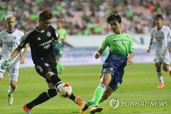 In this file photo taken on Aug. 6, 2017, Lee Dong-gook of Jeonbuk Hyundai Motors (R) battles Ulsan Hyundai goalkeeper Jo Su-huk in their K League Classic match at Jeonju World Cup Stadium in Jeonju, North Jeolla Province. (Yonhap)