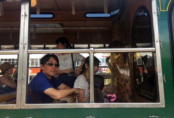 Visitors sit on a tour bus in Tumon, Guam Monday, Aug. 14, 2017. Tourists haven't been deterred from visiting the tropical island of Guam even though the US territory has been the target of threats from North Korea during a week of angry words exchanged by Pyongyang and Washington. (AP)