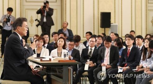 President Moon Jae-in (L) speaks at a press conference held at the presidential office Cheong Wa Dae on Aug. 17, 2017, marking his first 100 days in office. (Yonhap)