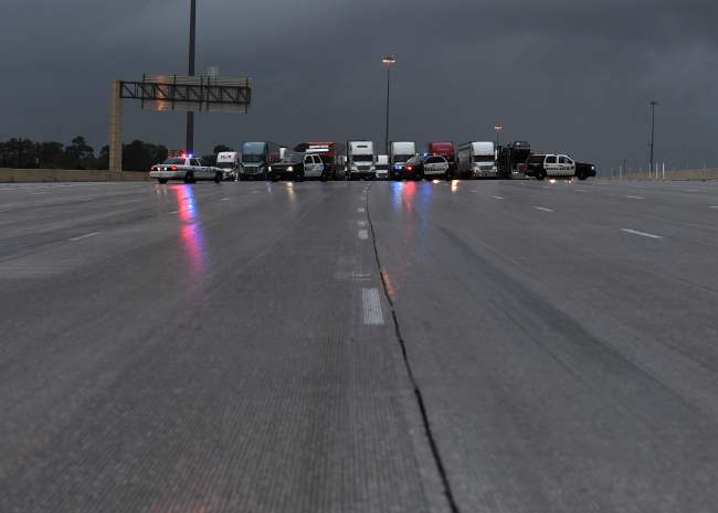 Police block traffic following closure of the I-10 freeway leading into Houston after Hurricane Harvey caused heavy flooding in Texas on Sunday. (AFP-Yonhap)