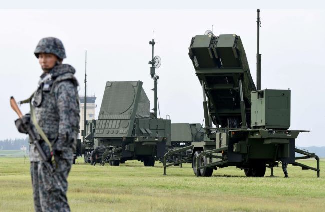 Soldiers from the Japan Air Self-Defense Force set up PAC-3 surface-to-air missile launch systems during a temporary deployment drill at US Yokota Air Bace in Tokyo on Tuesday. (AFP-Yonhap)
