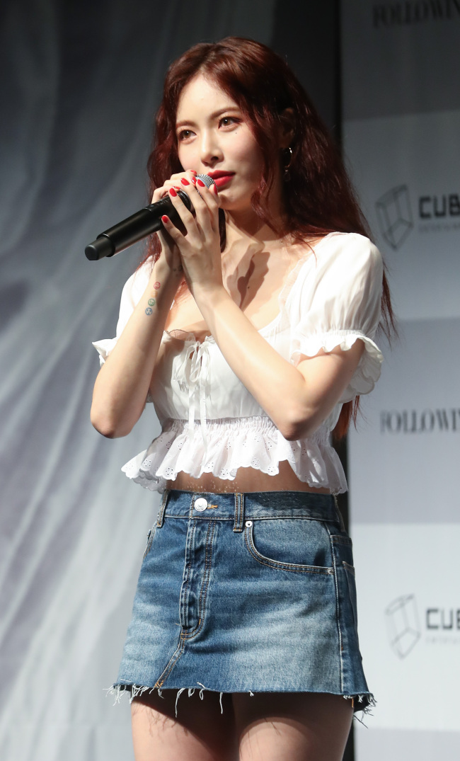 HyunA at the Following album press conference in Seoul, representing the subtle and slow-burning side of Aries fire sign energy