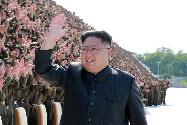 North Korean leader Kim Jong-un waves to soldiers in a photograph released by North Korea's state media. Yonhap
