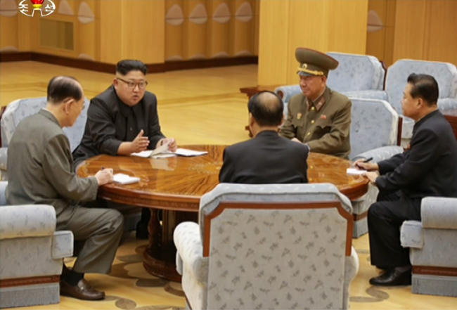 North Korean leader Kim Jong-un (second from left) holds a meeting with party officials, where according to North Korean state media, the decision to conduct Sunday's nuclear test was made. Yonhap