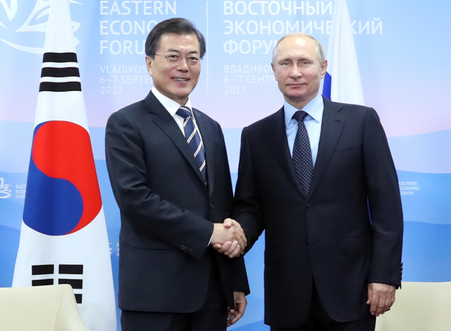 President Moon Jae-in (left) holds summit talks with Russian President Vladimir Putin in Vladivostok on Wednesday. (Yonhap)