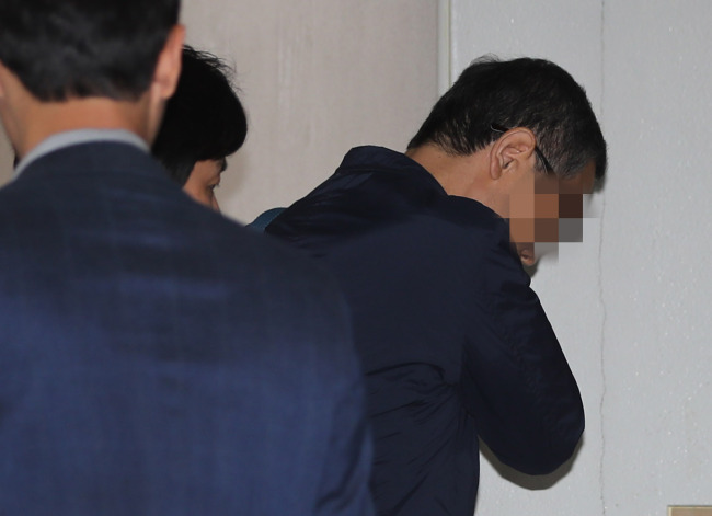One of the former National Intelligence Service officials, identified only by his surname Roh (Yonhap)
