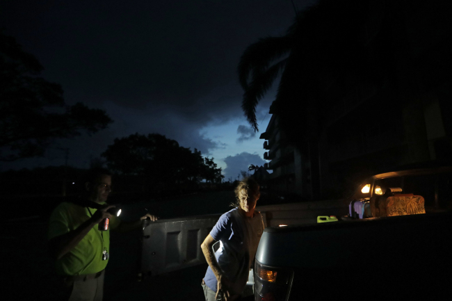 Laura and Joe Raymond pack up their truck to leave the fourth floor apartment of Joe's mother where they rode out Hurricane Irma to return to their low lying home a mile away in Marco Island, Fla., Monday, Sept. 11, 2017. (AP)