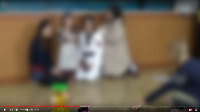 A screenshot of the Youtube video, where a father, disguised as a thief, threatens his child. (Save the Children)