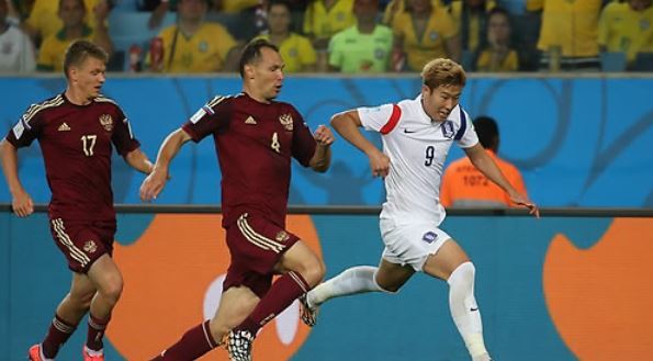 In this file photo taken on June 17, 2014, South Korea's Son Heung-min (R) dribbles past Russian defenders during the 2014 FIFA World Cup Group H match between South Korea and Russia at Arena Pantanal in Cuiaba, Brazil. (Yonhap)