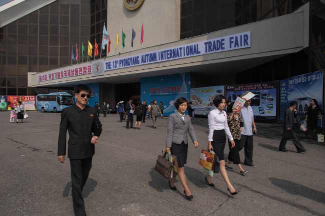 North Korean visitors leave the the 13th International Trade Fair in Pyongyang on Monday. (AFP-Yonhap)
