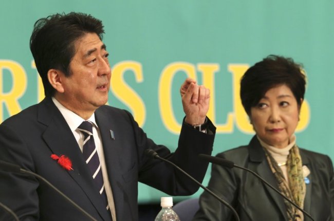 Ruling Liberal Democratic Party leader and Japan’s Prime Minister Shinzo Abe, left, speaks as Party of Hope leader Yuriko Koike, listens during their debate for the Oct. 22 lower house election in Tokyo, Sunday, Oct. 8, 2017