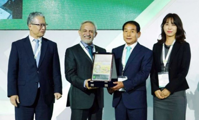 Kim Deok-ju (3rd from L), a senior official at the Dangjin muniipality on South Korea's west coast, receives a certificate on the registration of the city's Hapdeok Reservoir as a world heritage irrigation structure from Saeed Nairizi (2nd from L), chief of the International Commission on Irrigation and Drainage, during the commission's world congress in Mexico City on Oct. 10, 2017, in this photo released by the Dangjin municipality. (Yonhap)