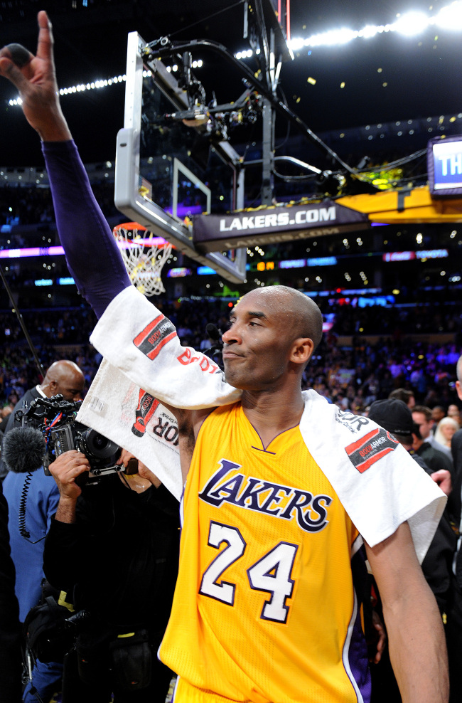 The Los Angeles Lakers’ Kobe Bryant salutes the crowd after his final game, on April 13, 2016, at Staples Center in Los Angeles. (TNS)