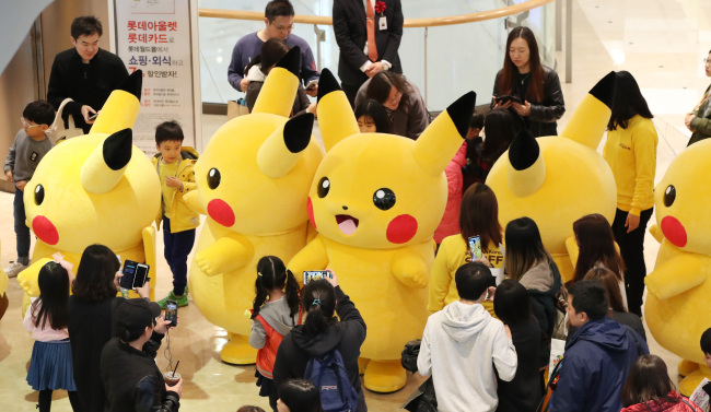 PIKACHU PARADE -- Several people dressed as “Pokemon” character Pikachu parade at the Pokemon Festa in Jamsil, Seoul, on Sunday. The festival at Lotte World Tower began on Saturday and runs through Nov. 12. (Yonhap)
