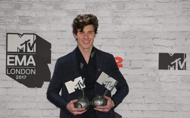 Canadian singer-songwriter Shawn Mendes poses with two of his three awards for best song for 'There's Nothing Holdin' Me Back', best artist and biggest fans in the winners' area during the 2017 MTV Europe Music Awards at Wembley Arena in London on Sunday.