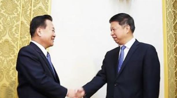 In this picture captured from the website of the International Liaison Department of the Communist Party of China, Song Tao (R), the head of the department, shakes hands with Choe Ryong-hae, a high-ranking North Korean official. (Yonhap)